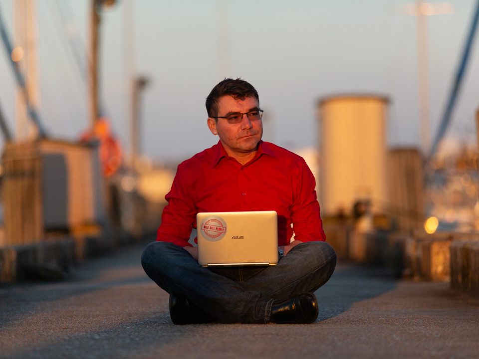 point2point Central CEO Michael Fredrick on the lakefront dock with a laptop